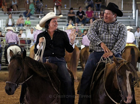 Cowgirl and cowboy havin' a talk before the rodeo.